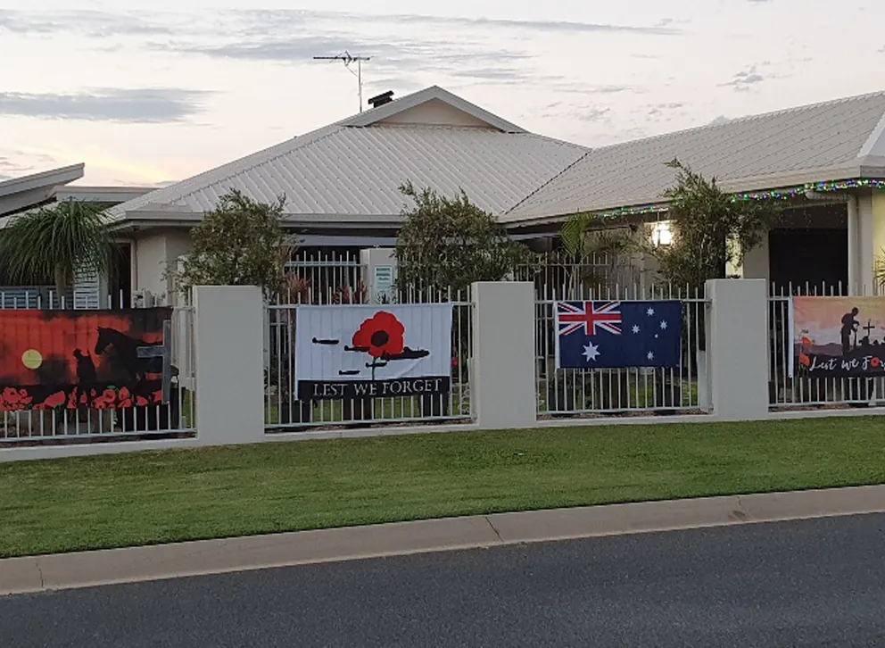 Lest We Forget Flag displayed on a fence